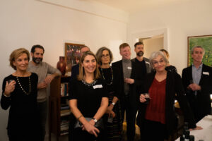 A group of people standing in a room. A group of people standing in a room.